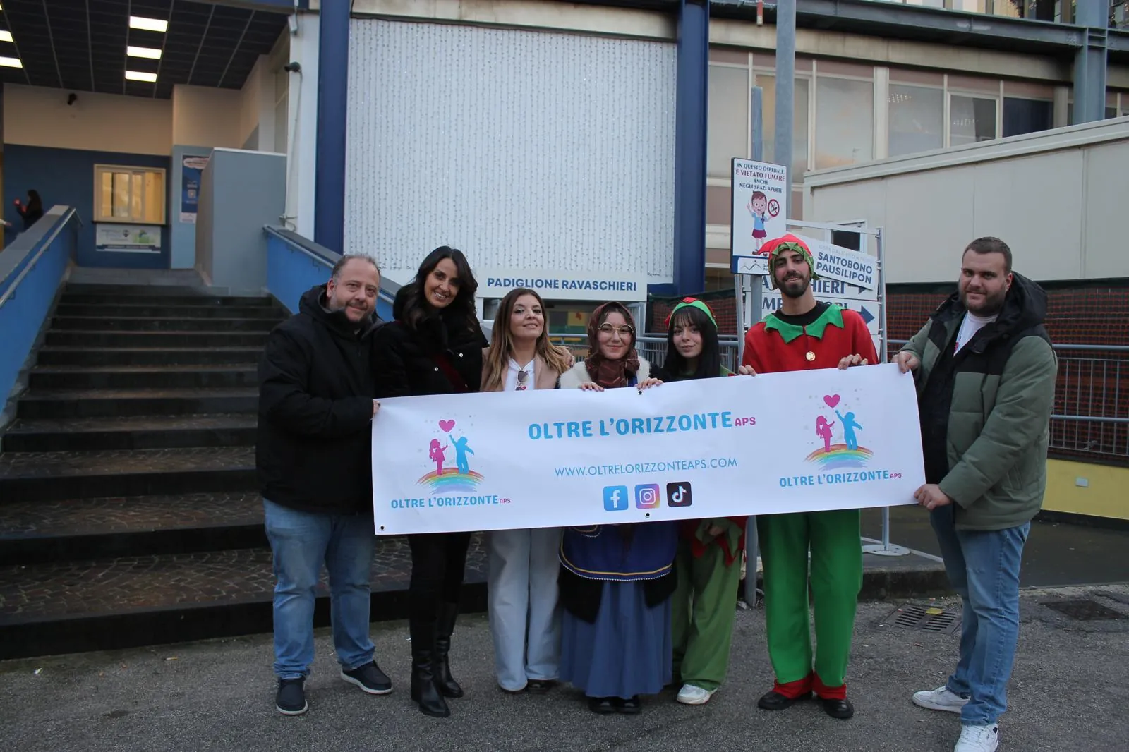I volontari con la Befana e due elfi davanti al padiglione Ravaschieri